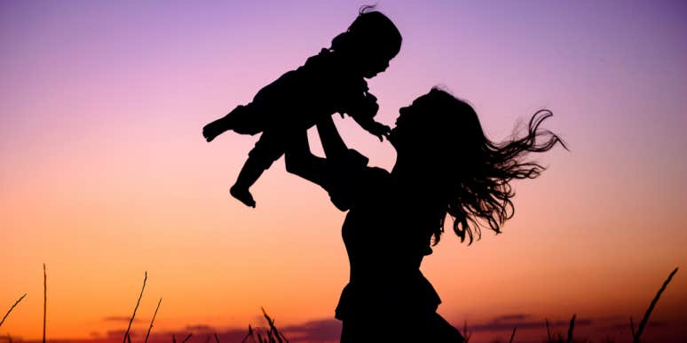 mom throwing baby in air