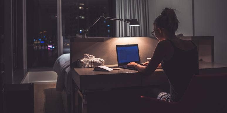 Woman sitting at her desk in the dark