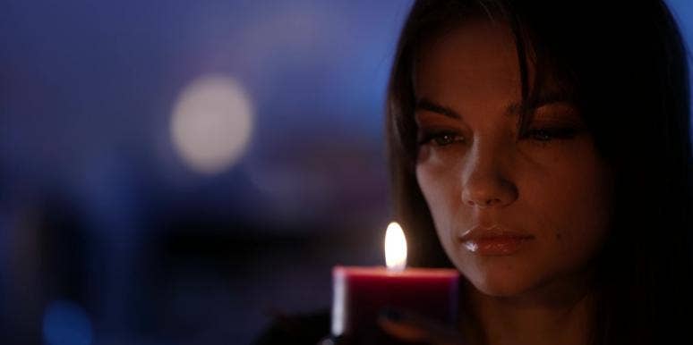 Why The Little Details You Overanalyze Are Actually Important woman analyzing candle