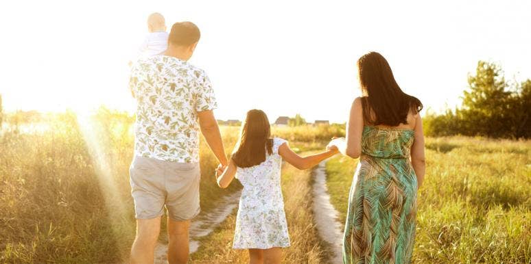 6 Reasons Why I Didn't Wait To Have More Kids family walking with kids in field