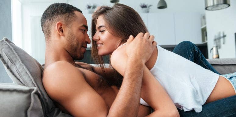 100 Best Dirty 'Would You Rather' Questions woman and man about to kiss on the couch