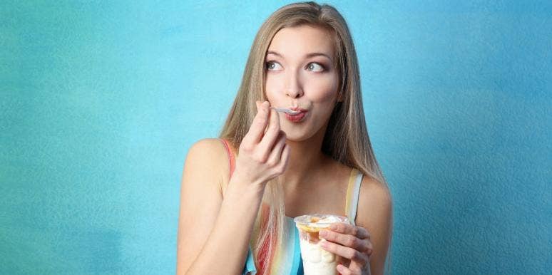 disordered eating woman eating ice cream in front of blue background
