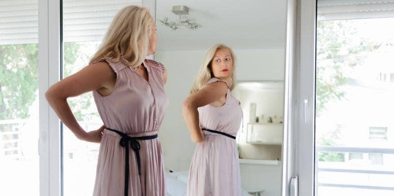 distorted body image woman looking in the mirror