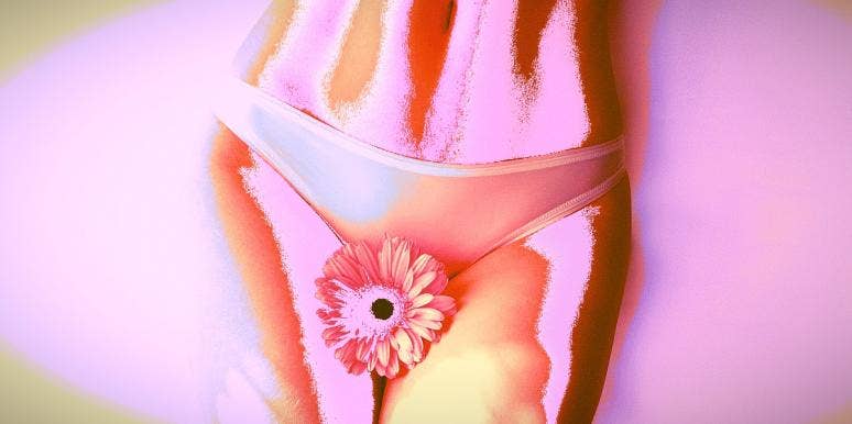 lower half of a woman's body with a flower in front