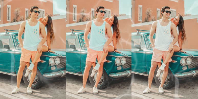 Couple hanging out by old care outside smiling