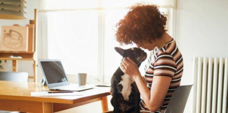 11 Common Dog Dream Meanings & Interpretations woman cuddling with a dog