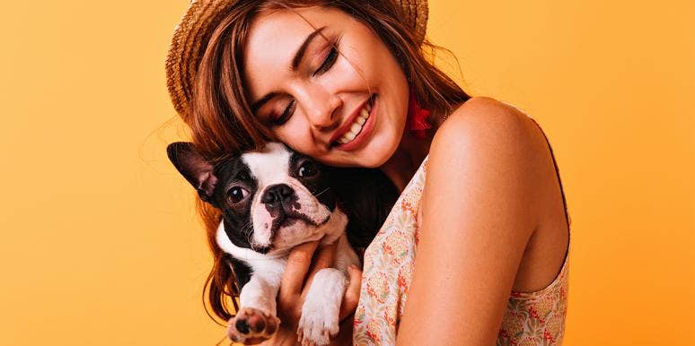 Your Dog Makes You 3x Hotter (And 8 Other Crazy Facts About Attraction) woman cuddling dog