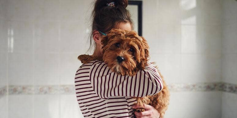 No, Your Dog Is Not Your "Baby" — Saying That Is An Insult To Moms woman holding dog