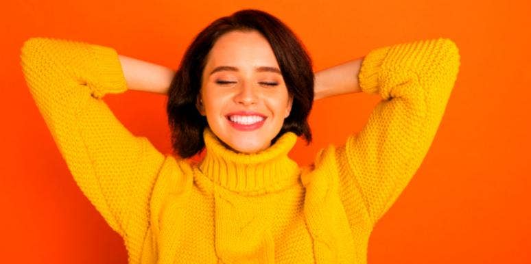 How Your Personality Type Affects Your Sleep Patterns, Sleep Habits, And Productivity woman in yellow shirt relaxing red background