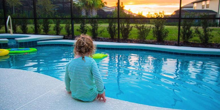 Baby Saved From Drowning By Heroic Big Brother And Mom toddler sitting by swinning pool