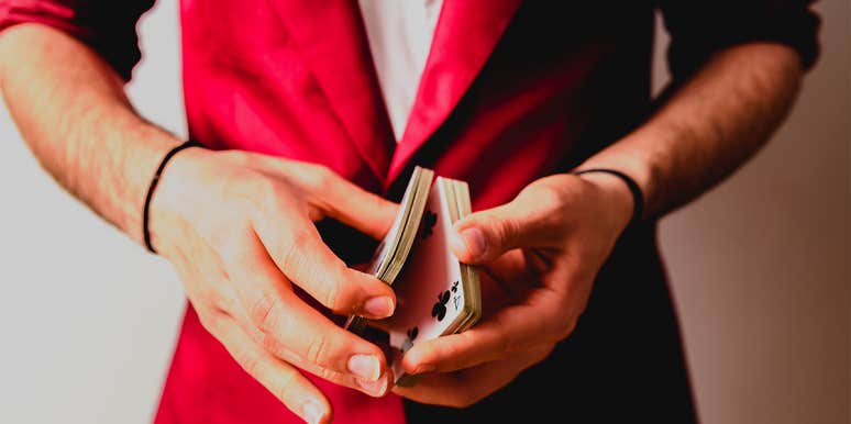15 Best Easy Card Tricks That Are Simple To Learn person performing card trick