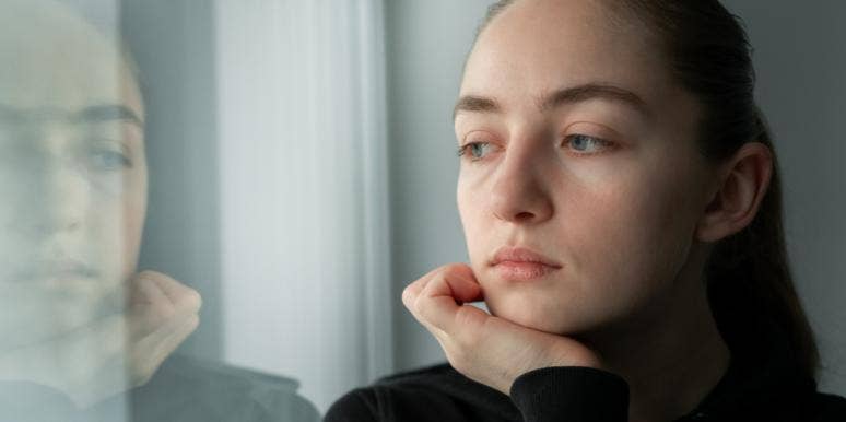 What Eating Disorder Recovery Is Like In A Society That Praises Weight Loss sad woman looking in window at reflection