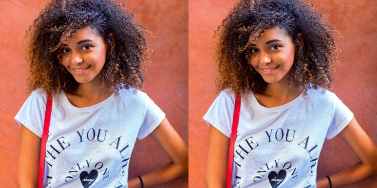 Why Your Ego Is Helpful In Living Your Best Life (Sometimes) young Black woman smiles at the camera on an orange background