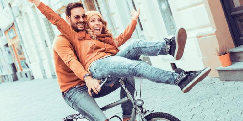 How Vulnerability And Affection Are Essential To Great Emotional Intimacy couple on bike together having fun