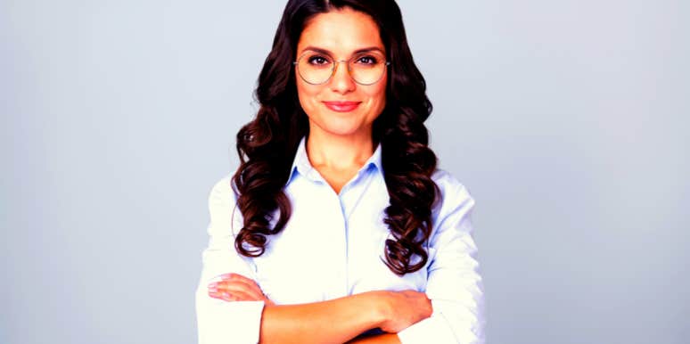 15 Signs Of Emotional Maturity To Look For In Yourself & Others cheerful emotionally mature woman with folded arms wearing glasses