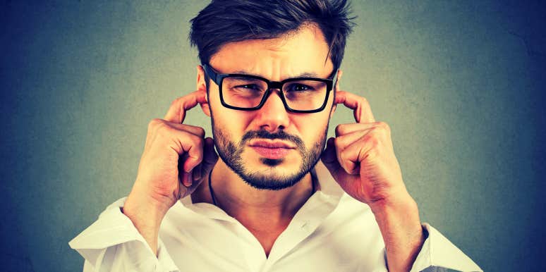 Emotionally Unavailable Men Share These 7 Characteristics emotionally unavailable man with his fingers in his ears