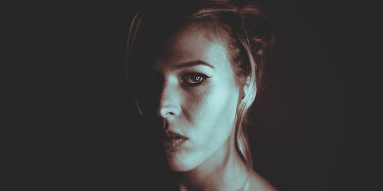 The Dark Side Of The ENFJ Personality Type woman staring forward in shadows