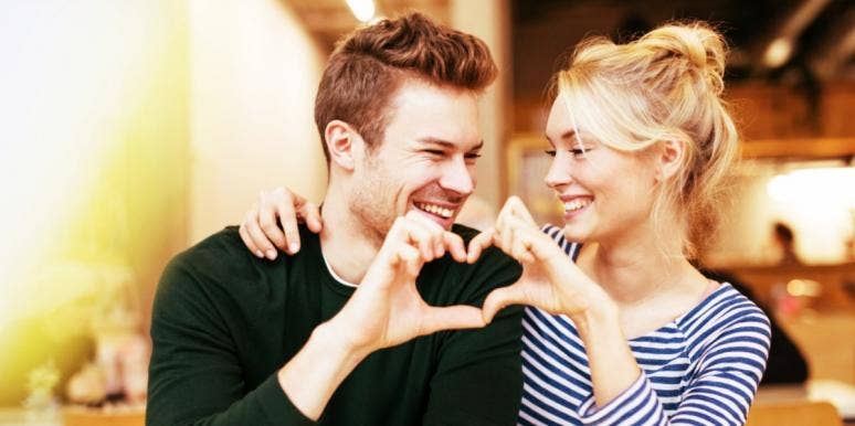 The Truth About How Enneagram Compatibility Works In Relationships man and woman making a heart together with their hands