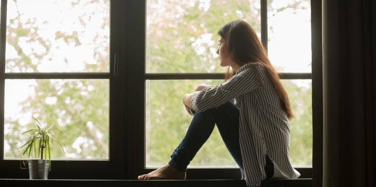 Quit Making Excuses For Him Because He Isn’t Interested In You woman looking out window