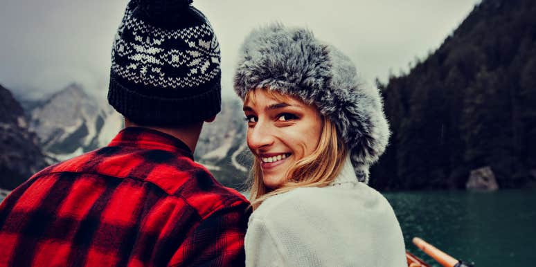 Relationship Experts' top red flags couple in a canoe, woman looking over shoulder deviously