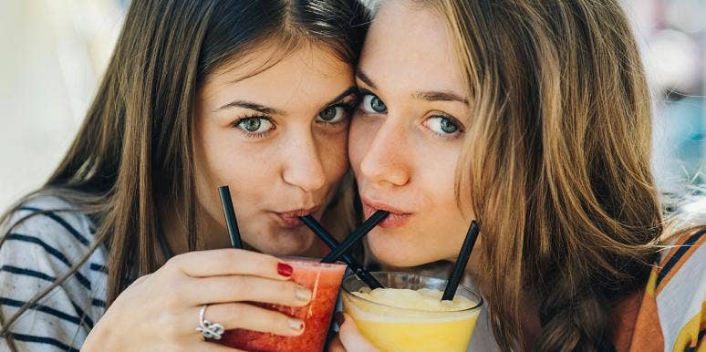 The Weird Thing Your Eye Color Says About Your Drinking Habits two women sipping drinks