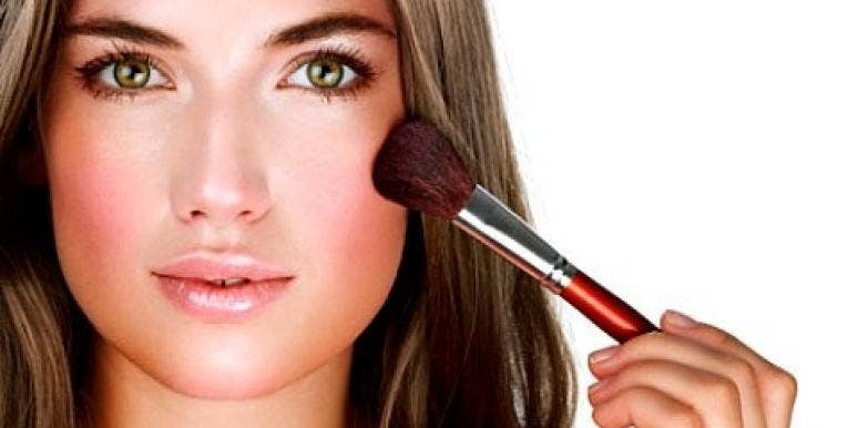 New Year's Eve makeup woman applying blush