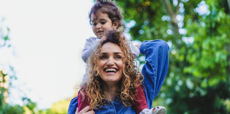 The Shocking Discovery I Learned From An Entire Year Of No Shopping mom carrying daughter on shoulders