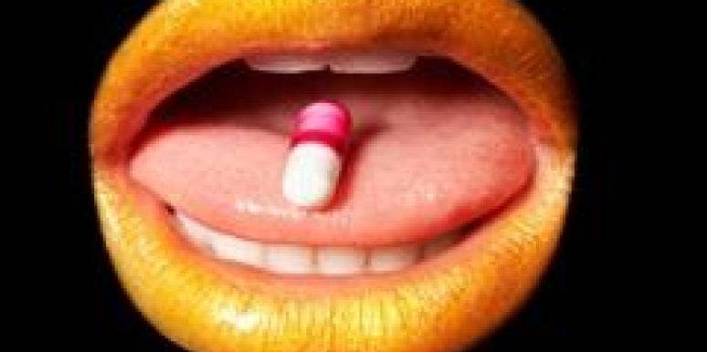 Will Science Fix The Female Orgasm? open mouth with pill on tongue