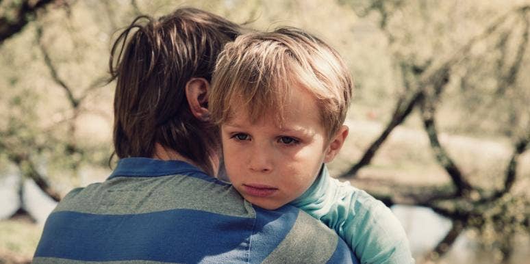 sad boy hugging father