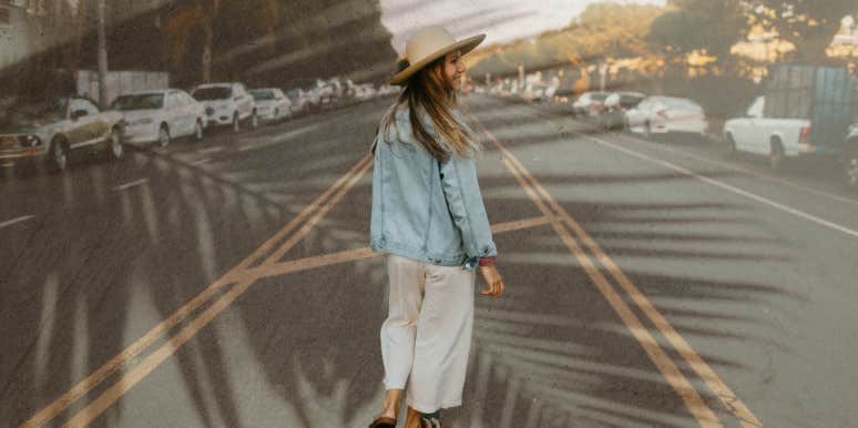 Woman walking down the middle of the road