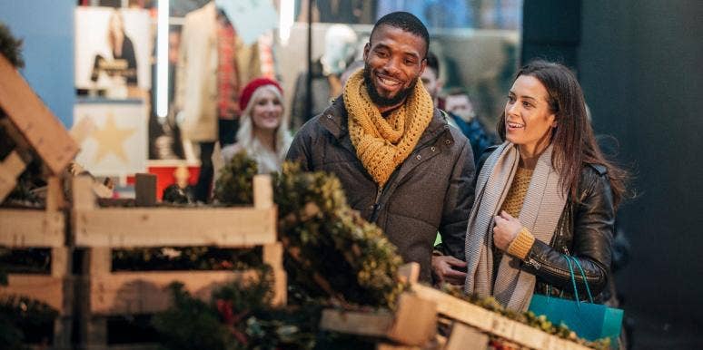 How To Focus On Holiday Joy In A Stressful Pandemic Year man and woman christmas tree shopping