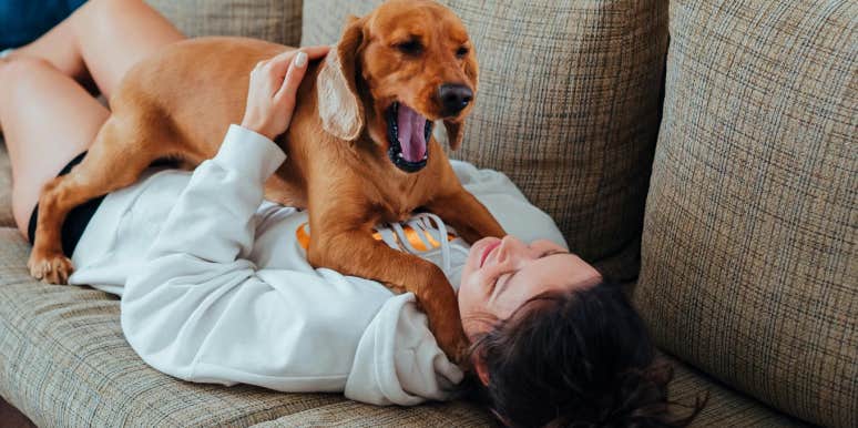 woman lying on couch with dog