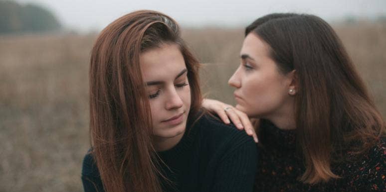 woman leaning on another woman friendship