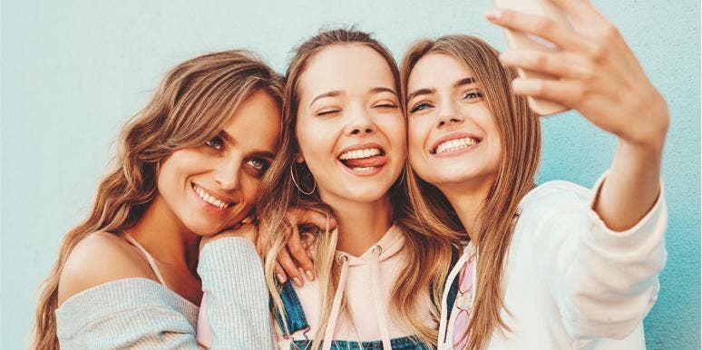 The Most Counterintuitive Way To Make People Like You More three friends taking selfies