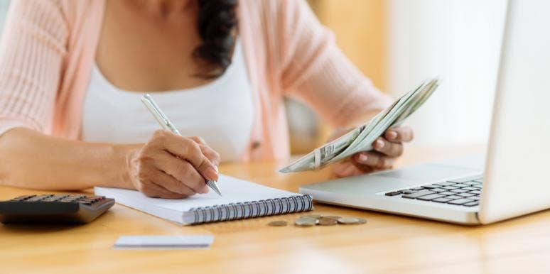 The Secret To Living A Life With A Full Bank Account woman creating a budget