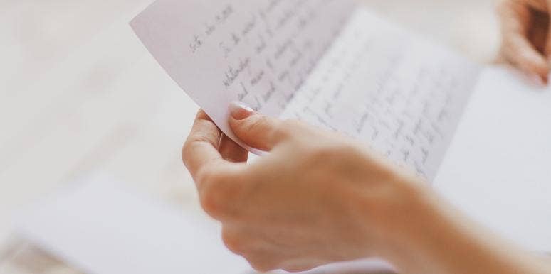 woman's hands holding a letter