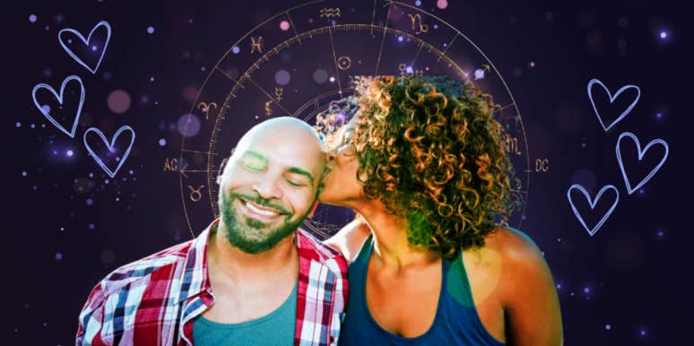 woman kissing man's head in front of a zodiac wheel