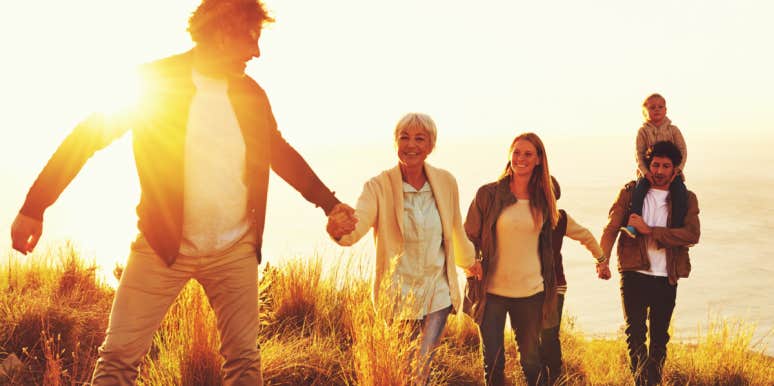 The most valuable gift for elderly relatives family hiking up a grassy hill