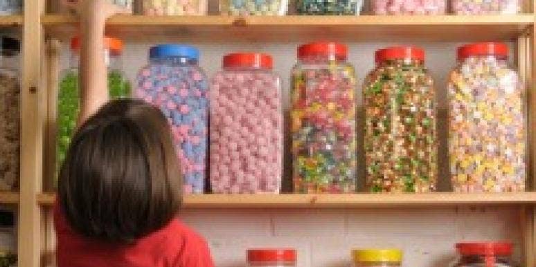 little girl reaching for candy