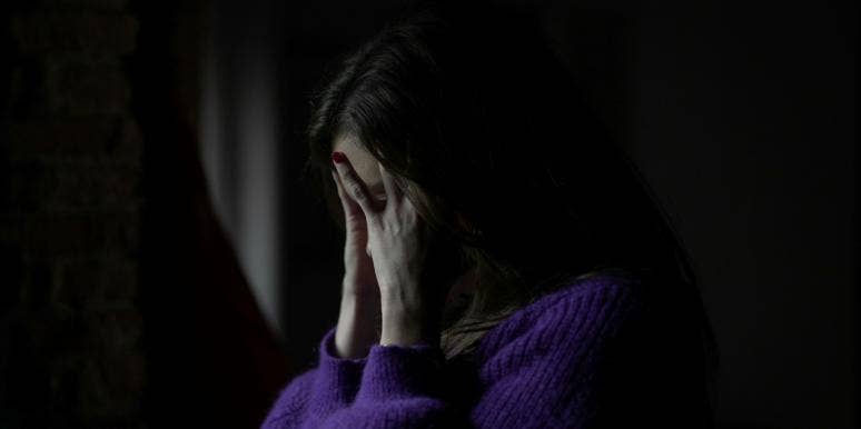 What Going Through A Break Up Is Like When You Have OCD woman in the dark with hands on her face