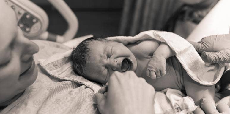 woman holding baby after giving birth