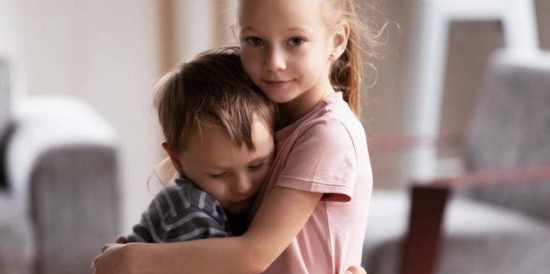 sister hugging little brother