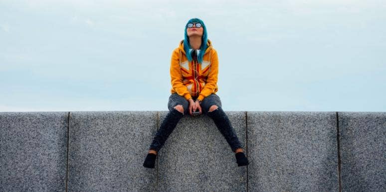 Why I Disappeared: To All The Guys I Never Texted Back woman on ledge with phone