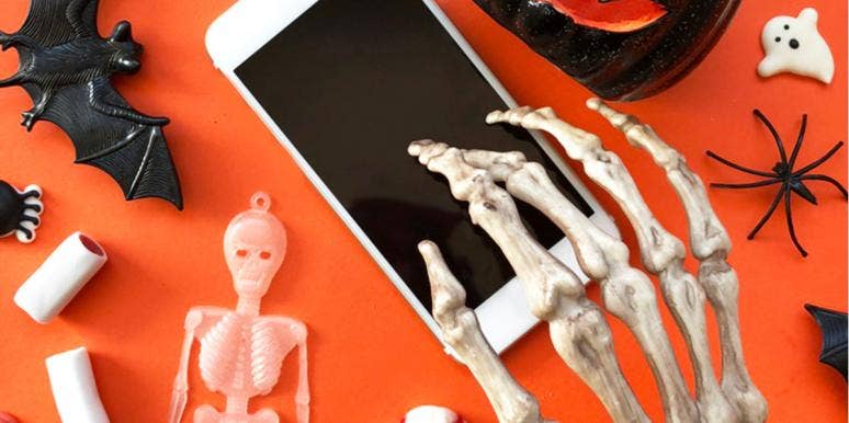 20 Halloween Icons, App Covers & Home Screen Themes For A Spooky Aesthetic skeleton hand on phone