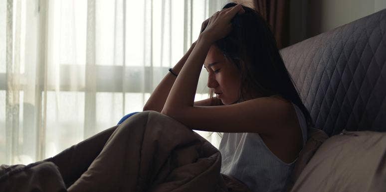 I Was Sexually Harassed By A Predator And Didn't Know It woman in bed sad