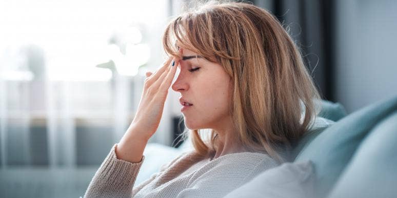 The Headache Halo Relieves Headaches & Migraines With Wearable Cooling & Compression woman with a headache