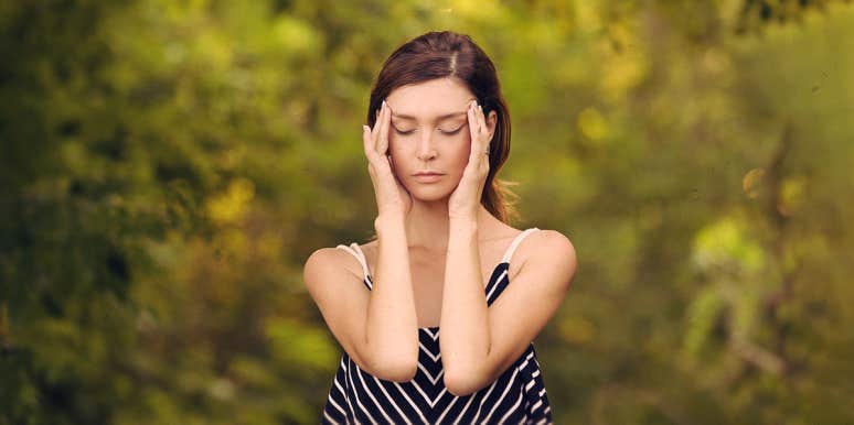 10 Spiritual Meanings Of Headaches woman with a migraine