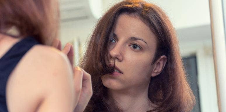 healing from a breakup woman looking in the mirror