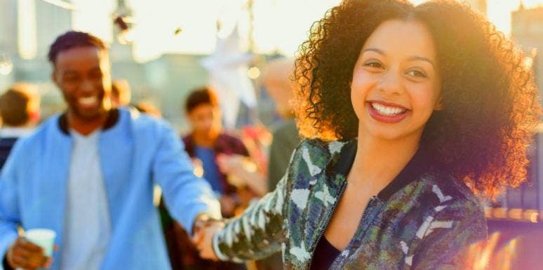 5 Ways Healthy Relationships Start On The First Date man and woman laughing and holding hands