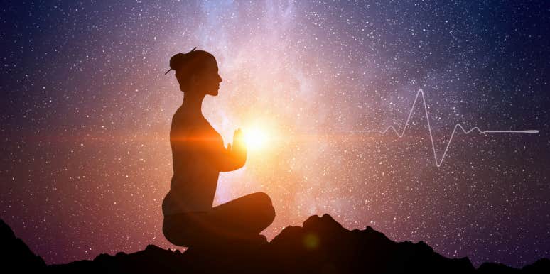 How To Do The Heartbeat Method In 6 Steps woman meditating with heartbeat pulsing